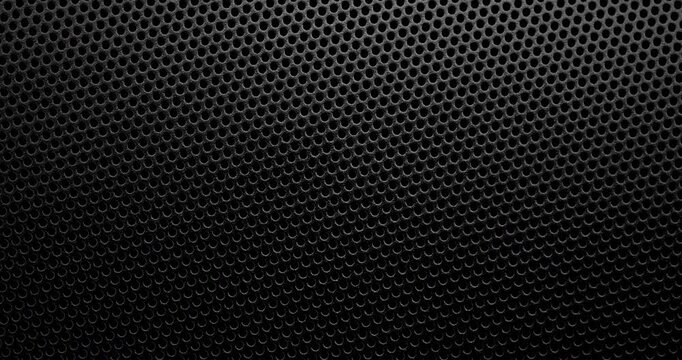 Black Perforated Metal Mesh. Smooth slow movement across extreme close-up of dark perforated metal grid with dramatic side lighting.
