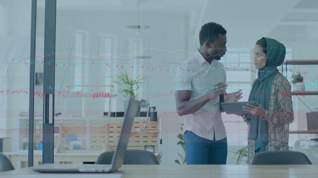Man tapping tablet to show data, woman reviewing screen, charts appearing, driving data decisions