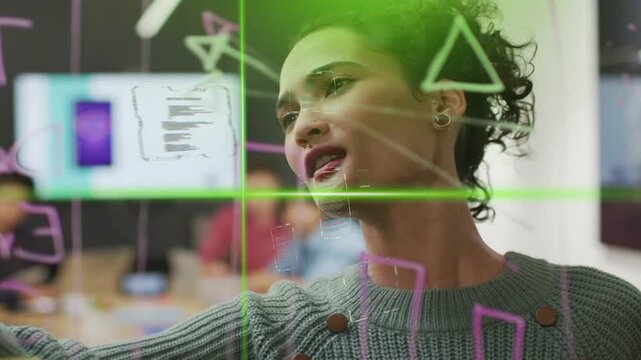 Woman stepping to glass board and leading design, drawing shapes refining plan with green guides