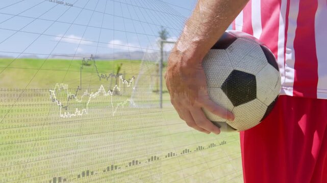 Male soccer player holding ball, sports data overlay fading in and causing grip tweaks for analysis