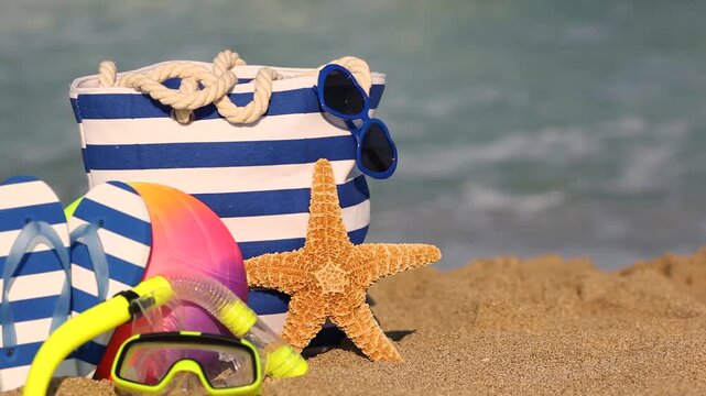 Beach bag is standing on yellow sand against sea. Slow motion