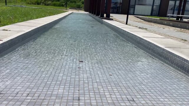 Tilt Up of Long Water Fountain in Nesebar Bulgaria, Sunny Day, 4K Horizontal