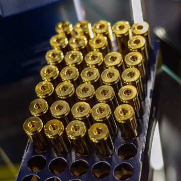 Rows Of Brass Cartridge Casings In A Blue Box