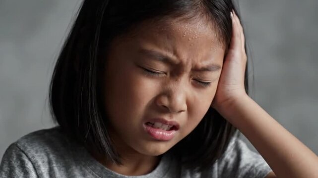 Young girl experiencing ear pain and discomfort