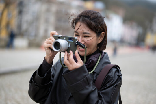 woman taking picture with a classic range finder camera