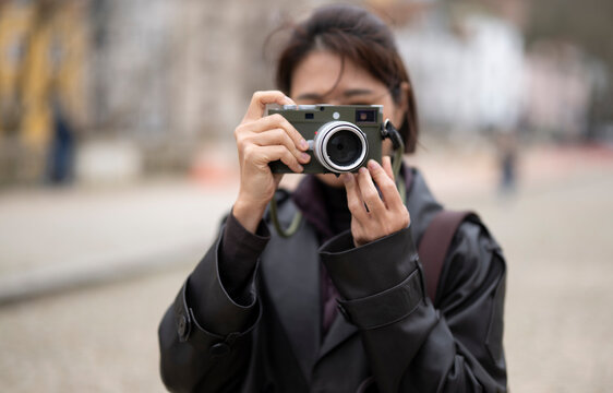 woman taking picture with a classic range finder camera