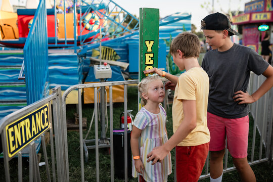 Kids eagerly checking height before carnival ride