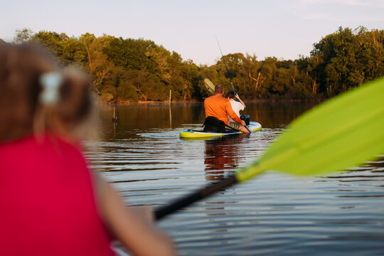 Family Paddleboarding and Fishing on Lake