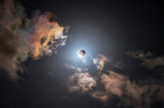 Eclipsed Moon Surrounded by Vibrant Night Clouds
