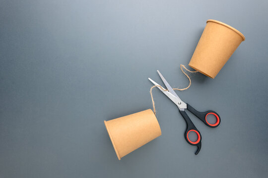 Broken communication and social disconnection concept with cut string phone