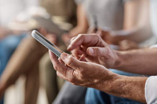 Audience, hands and person on mobile app in seminar for online notes, info or digital interaction. Event, crowd and man with phone at conference for live poll software, survey response and networking