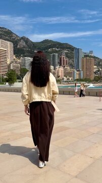 A girl walks along the promenade in Monaco, Monte Carlo