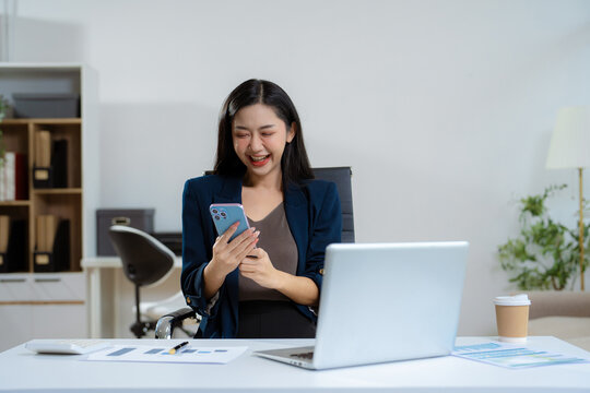 Overjoyed charming excited woman business woman worker using smartphone.