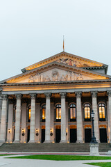 Naklejka premium Elegant European architecture featuring ornate facades, classical columns, and historic buildings in an urban city setting. A collection of architectural details including balconies and illuminated