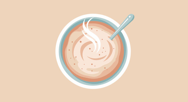 Overhead view of a warm bowl of soup with spoon on a light background