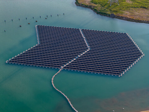 Aerial view of floating solar panel array on a lake in Bensheim, Hessen, Germany.