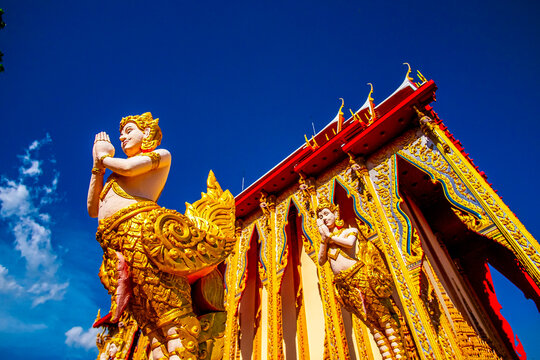 Exquisite Golden Kinnara Statues Guarding Traditional Thai Temple