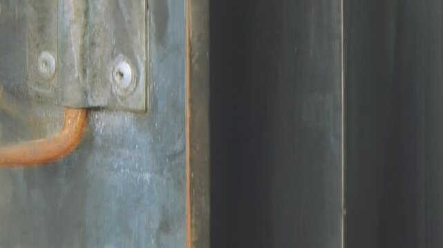 Close-up of a powerful industrial air filter unit actively purifying air. Robust blades spin, circulating unseen currents within a factory setting, ensuring clean breath during operational moments.