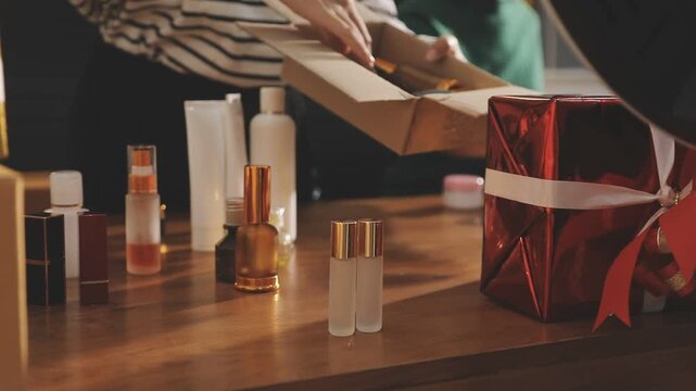 Young beautiful Asian girl reviewing cosmetic and skin care product with new collection's promotion selling on social media online live blurred phone screen surrounded beauty merchandise. Stratagem.
