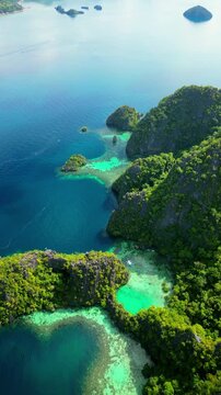 Cinematic aerial panorama of Coron islands-Iconic limestone cliffs, hidden emerald lagoons, and crystal clear turquoise water in Palawan, Philippines