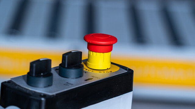 Emergency stop button and selector switches on industrial machine