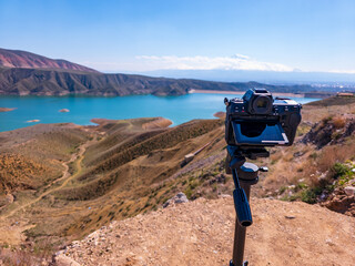 Photographer's setup overlooks beautiful alpine lake with clear blue skies © Levon