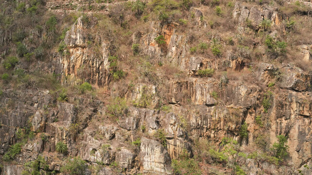 Natural Rocky Cliff Face Texture on Dry Mountain Slope in Daylight