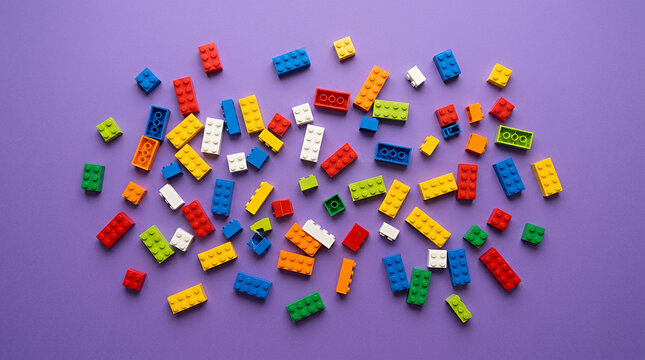 Colorful LEGO circular pattern on a vibrant purple background with copy space
