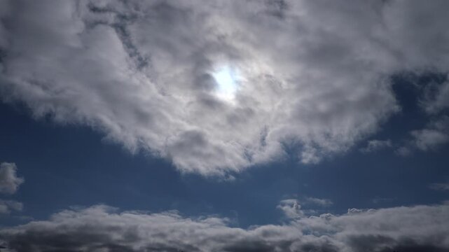 Clouds slowly dissolve revealing the blue sky
