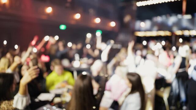 Crowd cheers excitedly. Energetic audience capturing moments during lively nighttime music celebration