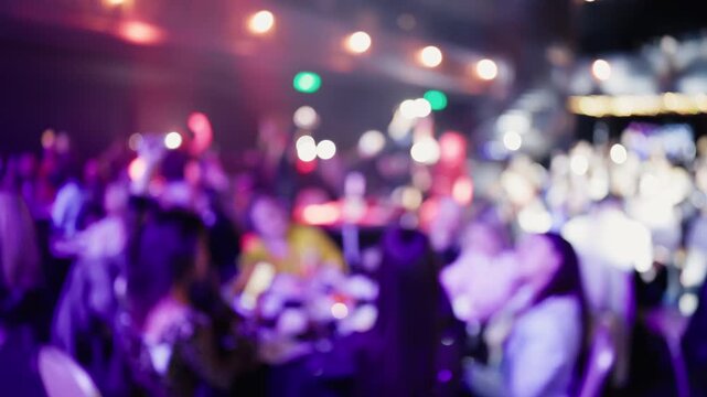 Nightlife lively scene. Energized crowd enjoys rhythmic beats under glowing purple illumination and fog