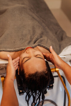 Woman enjoying a soothing head massage after jade mask therapy and water halo treatment at a relaxing Japanese head spa.