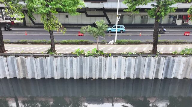 Sustainable Urban Planning for Future Cities Aerial view of bridge foundation construction on a river, featuring heavy steel sheet piling, concrete reinforcement, and a tall tower crane on a cofferdam