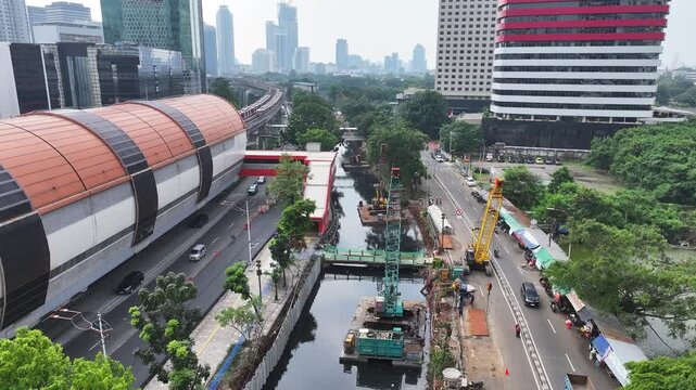 Sustainable Urban Planning for Future Cities Aerial view of bridge foundation construction on a river, featuring heavy steel sheet piling, concrete reinforcement, and a tall tower crane on a cofferdam