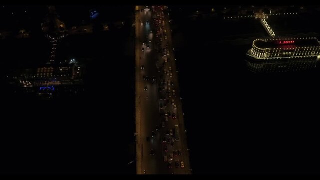 Qasr El Nil Bridge, Egypt, Nile River Traffic and Gezira Club Cityscape at Night, Cinematic Pull-Away revealing Shot, Drone Footage
