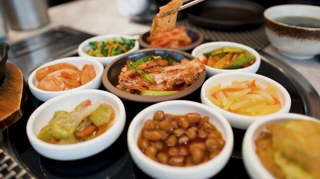 Assorted Korean Banchan Side Dishes Served in a Restaurant Setting