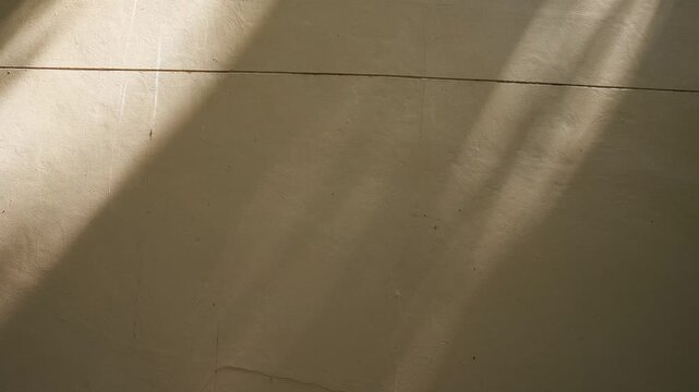 Abstract shadow waves moving across textured wall in atmospheric 4k video footage