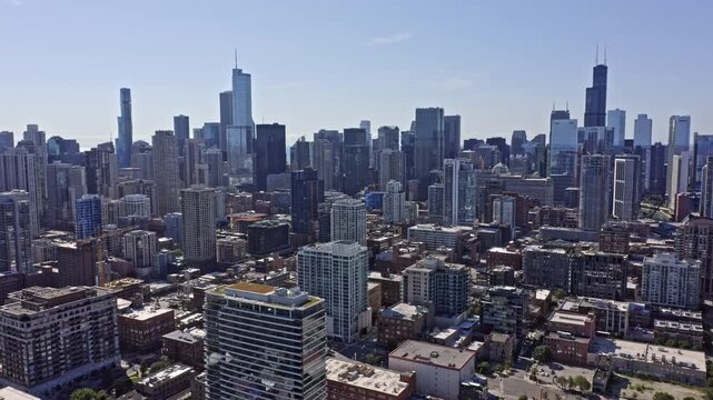 Aerial view of Chicago skyline during sunny day showing Willis Tower and downtown skyscrapers in Illinois.