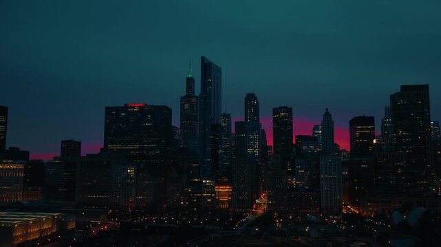 Stunning cinematic aerial view of Chicago skyline at dusk with vibrant pink and teal sunset in motion.