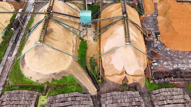 Aerial view of wood chip piles at a paper mill factory