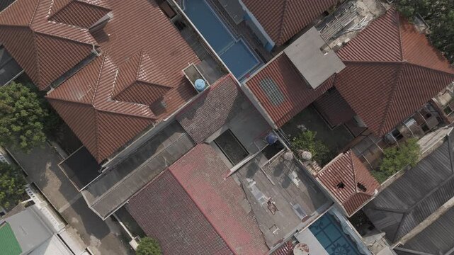 Shot in D-Log M for professional color grading Aerial view increasing altitude over suburban rooftops