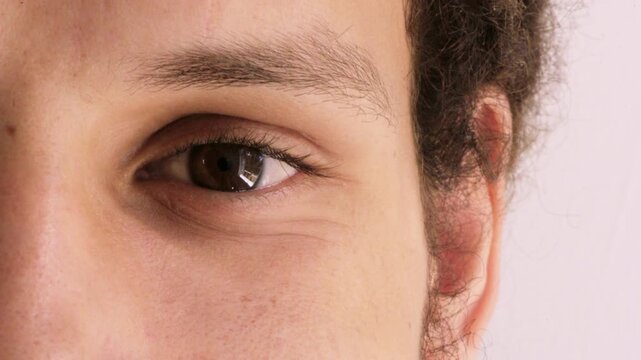 Eyesight, optometry and face of man in studio with vision, optical health or glaucoma test. Ophthalmology, wellness and portrait of person with eyecare or laser treatment results by white background.