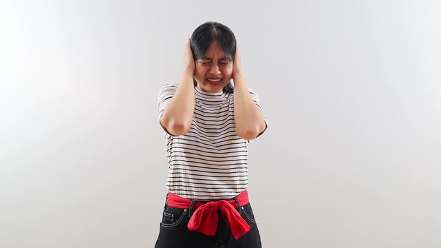 Unhappy sad angry asian woman close eyes and cover ears by hands being annoyed with loud noise, emotions, dislike loud sounds