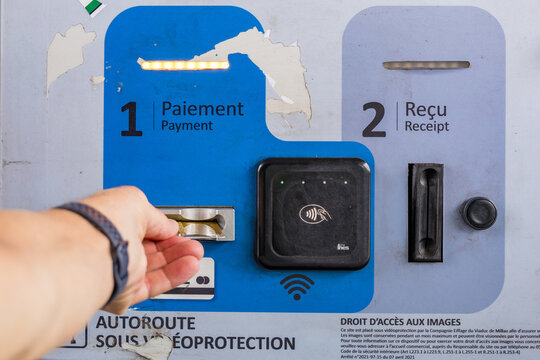 Hand Inserting Card at Millau Viaduct Toll Payment Terminal France