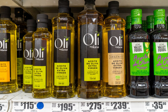 Villa de Alvarez, Colima. Mexico. April 14, 2026: Various Bottles of Extra Virgin Olive Oil Labeled and Arranged on a Store Shelf