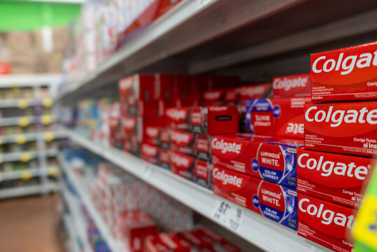 Villa de Alvarez, Colima. Mexico. April 14, 2026: Rows of Red and Blue Toothpaste Boxes Displayed on a Retail Store Shelf. Colgate