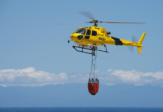 Tenerife, Spain may 8st, 2026. A&eacute;rospatiale AS 350B3 Ecureuil Eliance airlines,Tenerife Airport. A helicopter of the fire service with a fire fighting bucket is taking part in putting out a fire