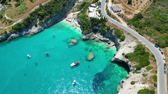 Spectacular drone view of Xigia Sulfur Beach in Zakynthos. Famous for its healing sulfur springs, crystal turquoise water, and steep limestone cliffs in a scenic Greek island bay.