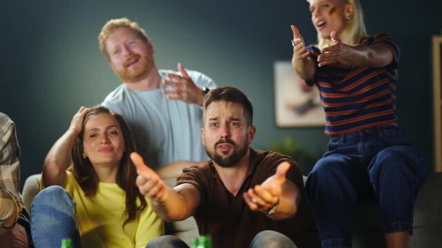 Group of emotional soccer fans reacting with frustration and disappointment while watching football match together at home. Supporters upset during intense game moment.