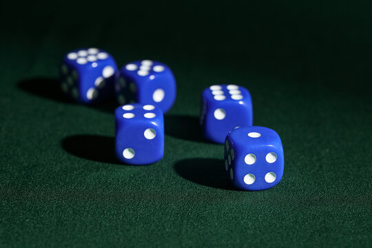 Blue game dices on green background